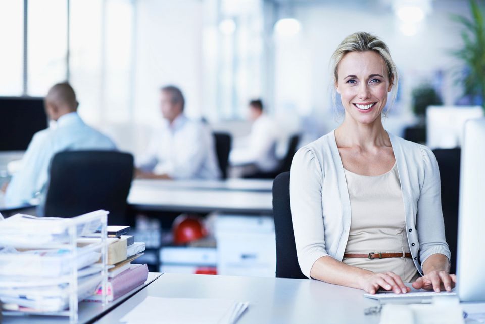 smiling female office worker at her desk